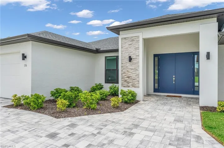 Property entrance with a garage and french doors