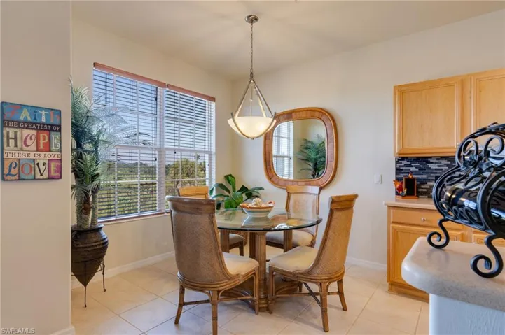 Dining area with light tile patterned floors and baseboards