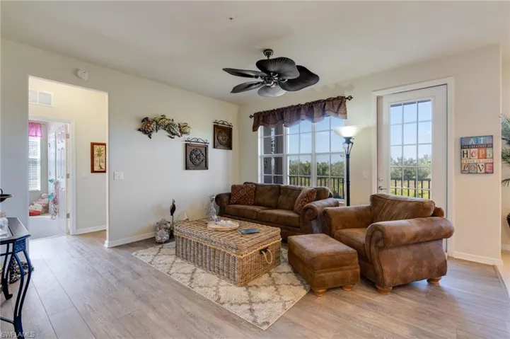 Living area featuring light wood-style flooring and a ceiling fan