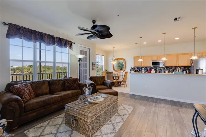 Living room featuring ceiling fan, light wood-style flooring, and recessed lighting