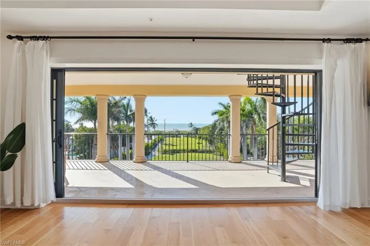 Doorway to outside featuring hardwood / wood-style floors and stairway