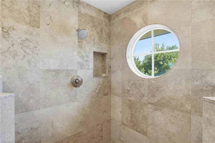 Full bath featuring tiled shower