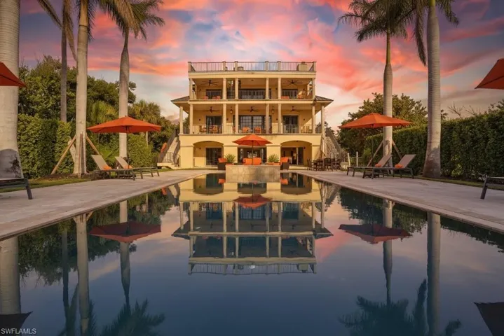 Outdoor pool with a balcony and a patio