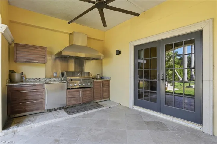 View of patio with french doors, an outdoor kitchen, and a ceiling fan