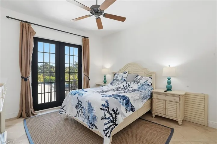 Bedroom with french doors, access to exterior, and ceiling fan