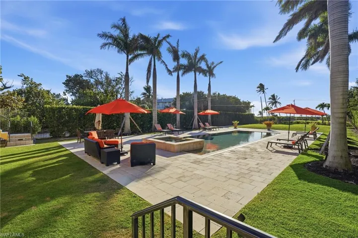 Combined pool / hot tub featuring a yard, a patio, and an outdoor hangout area