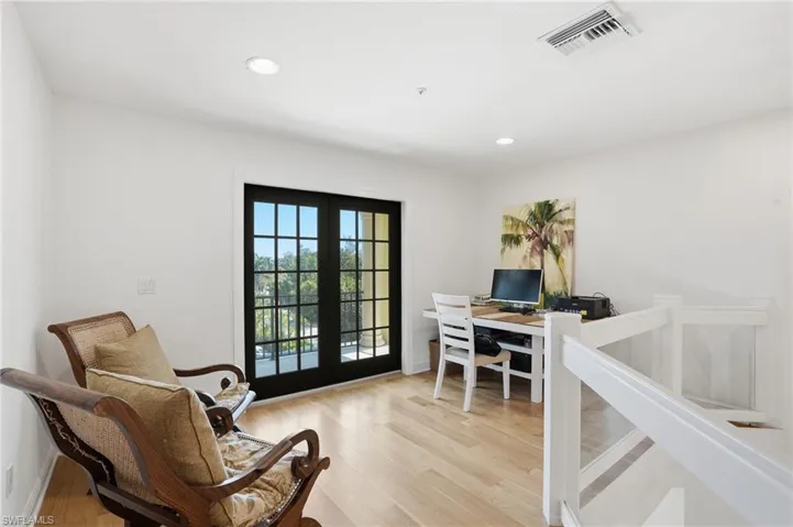 Office with french doors, light wood finished floors, and recessed lighting