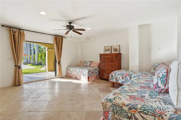 Bedroom featuring access to exterior, a ceiling fan, recessed lighting, and stone tile flooring