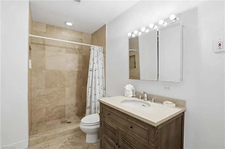 Bathroom with vanity and a stall shower