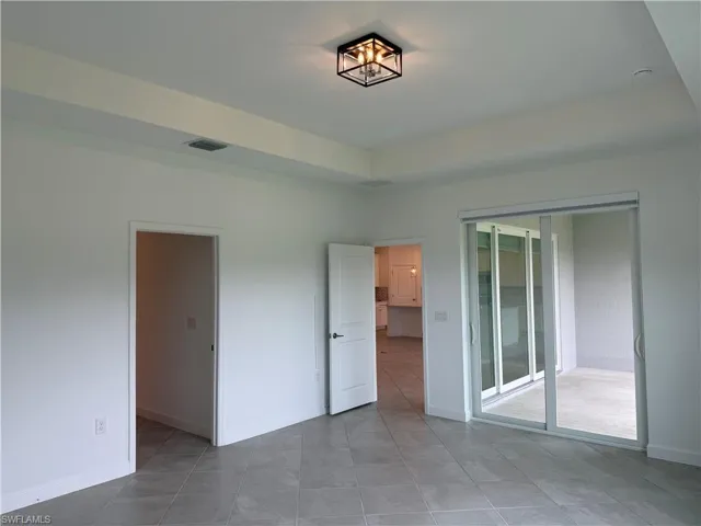 Primary bedroom featuring light tile patterned flooring