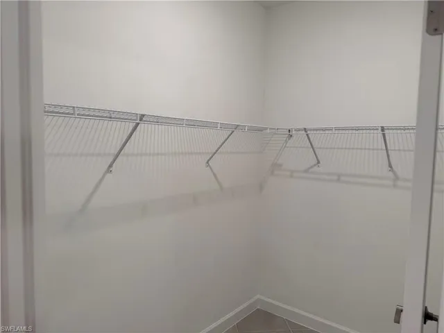 Walk in closet featuring tile patterned flooring