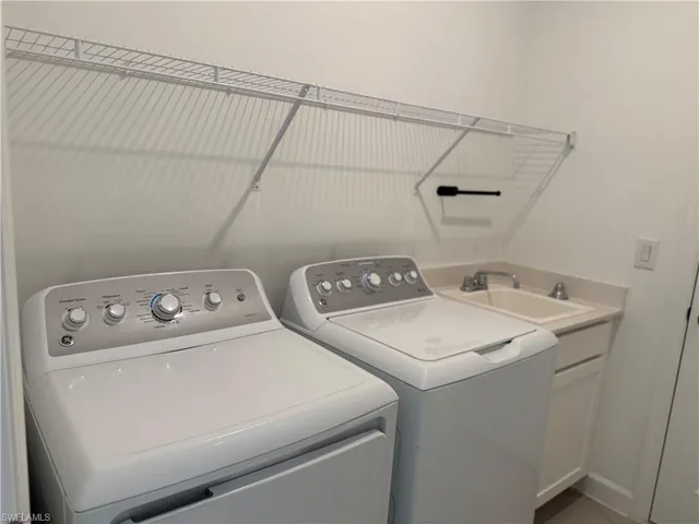 Laundry room with washing machine and dryer and cabinet space