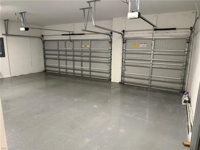 Garage featuring electric panel and a garage door opener