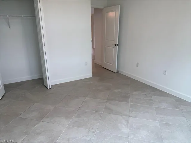 bedroom 3 with baseboards and a closet