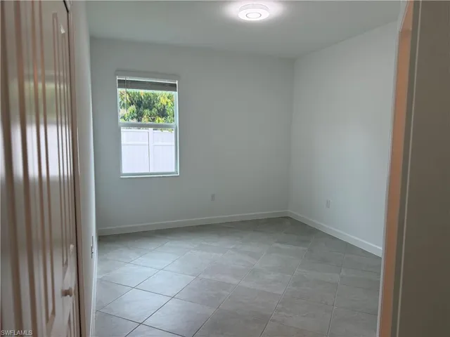 Bedroom 1 with light tile patterned floors