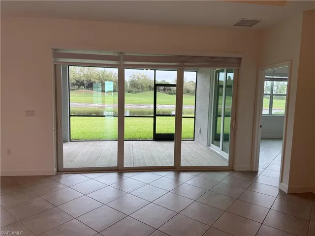 Entryway featuring a water view and tile patterned flooring