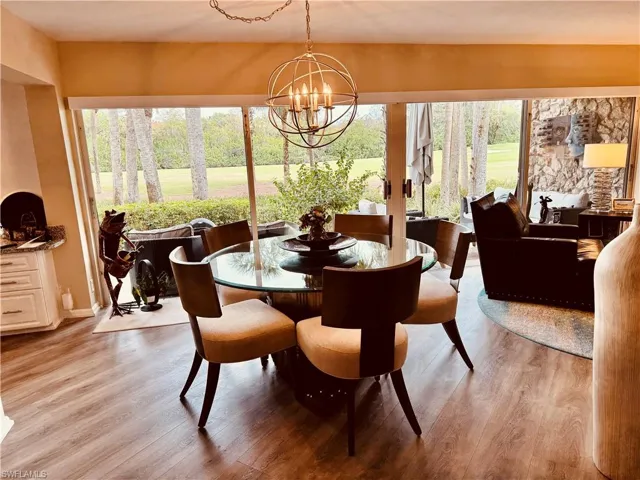wood-type flooring and a chandelier
