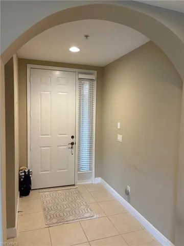 Kitchen featuring white appliances, light countertops, white cabinets, and recessed lighting