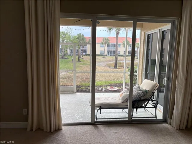Doorway to outside with carpet floors
