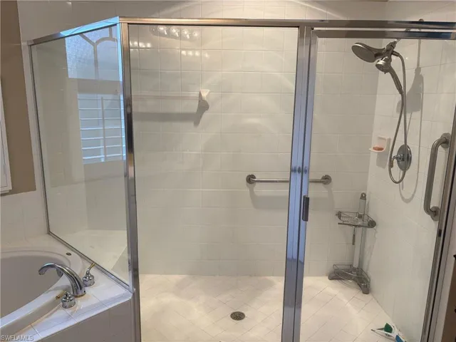Full bathroom featuring a garden tub and a stall shower