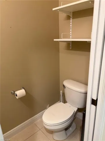 1/2 Bathroom with baseboards and light tile patterned floors