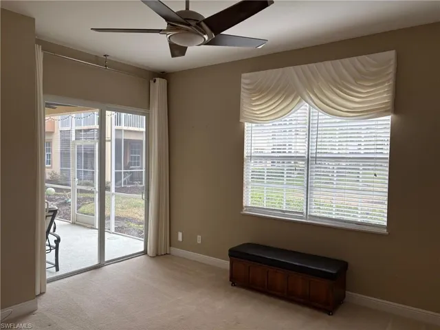 Spare room with ceiling fan and light colored carpet