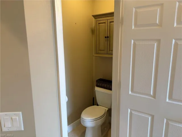 Bathroom with toilet and tile patterned floors