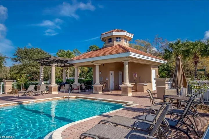 Community pool with a patio area and a pergola