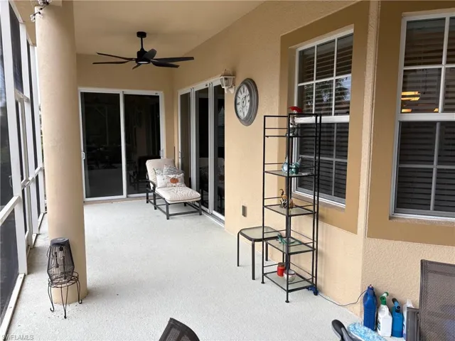 Sunroom / solarium featuring ceiling fan and a patio area