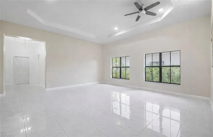 Spare room featuring ceiling fan, a tray ceiling, and recessed lighting