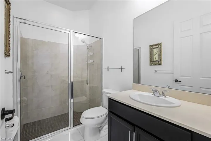 Bathroom featuring vanity and a shower stall
