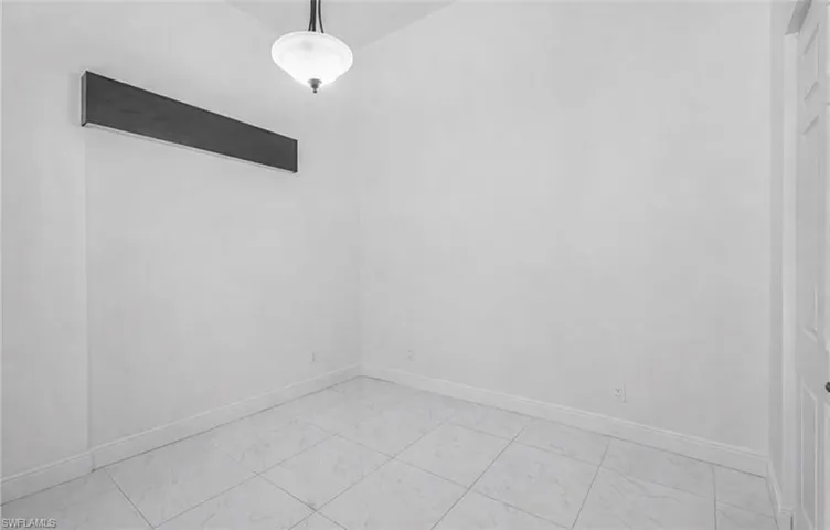 Empty room featuring baseboards