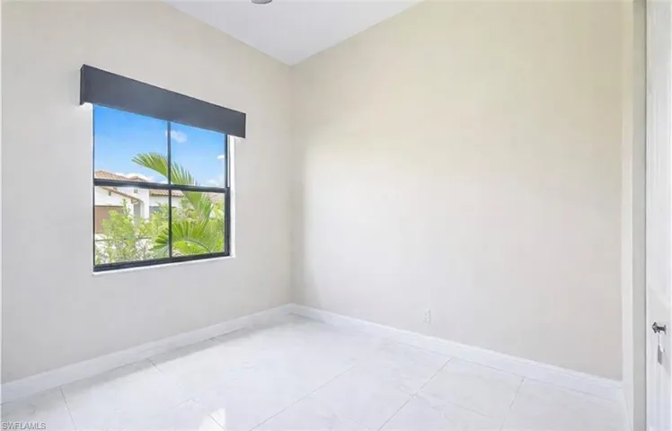 Empty room featuring baseboards