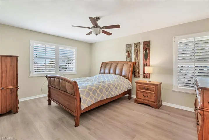 Bedroom with ceiling fan and light hardwood / wood-style floors