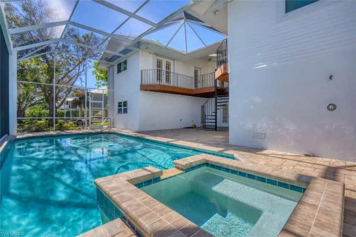 View of pool featuring an in ground hot tub, french doors, a patio, and a lanai
