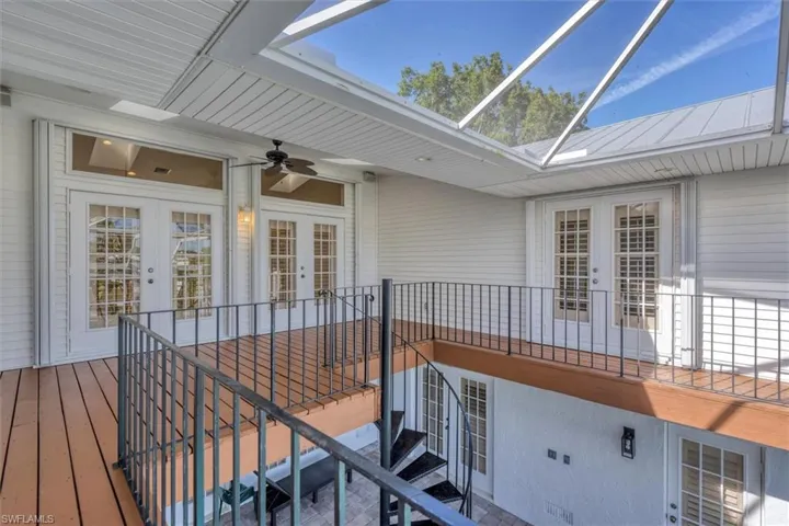 Deck featuring ceiling fan and french doors