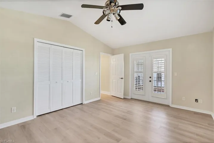 Unfurnished bedroom featuring access to outside, ceiling fan, french doors, and light wood-type flooring