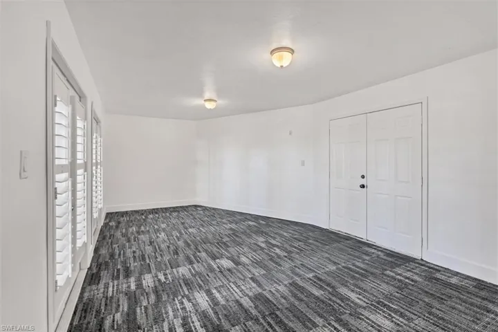 Empty room with dark carpet