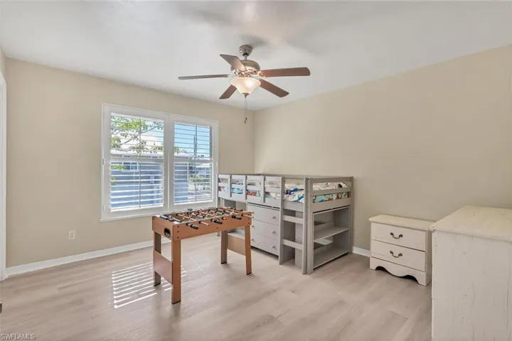 Bedroom featuring ceiling fan and light wood-type flooring