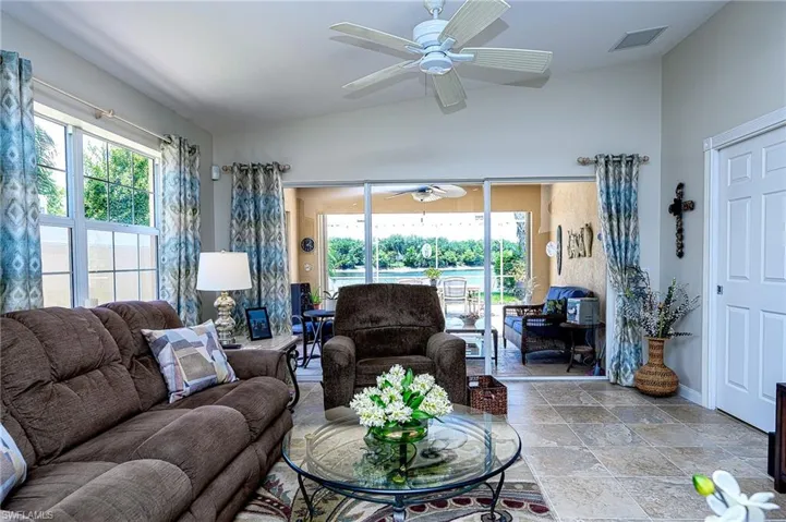 Living room with tile floors and ceiling fan.