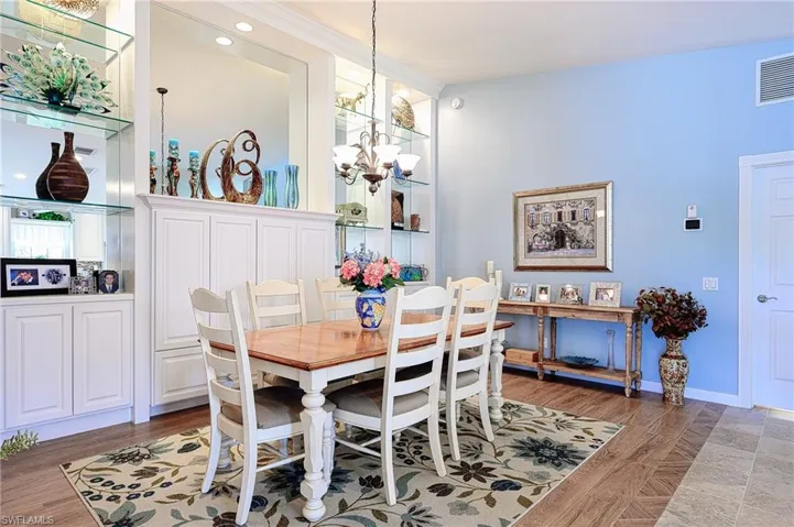 Great Room/Dining Room with custom built in wall unit and wood looking tile flooring