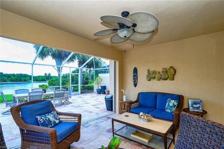 View of LANAI with outdoor covered lounge area, ceiling fan, and a great water view with custom Lanai floor