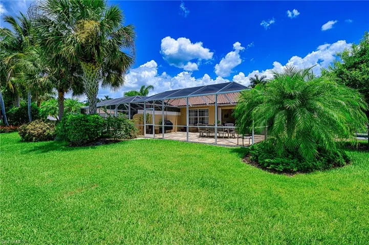 View of backyard with screen enclosed lanai