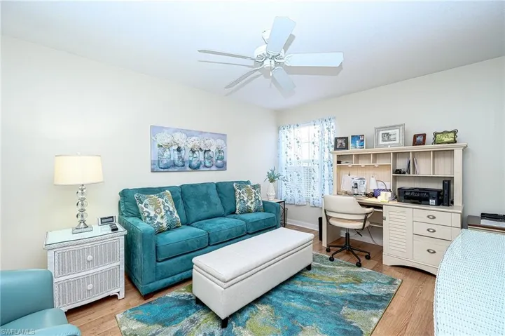 guest bedroom/office with walk in closet