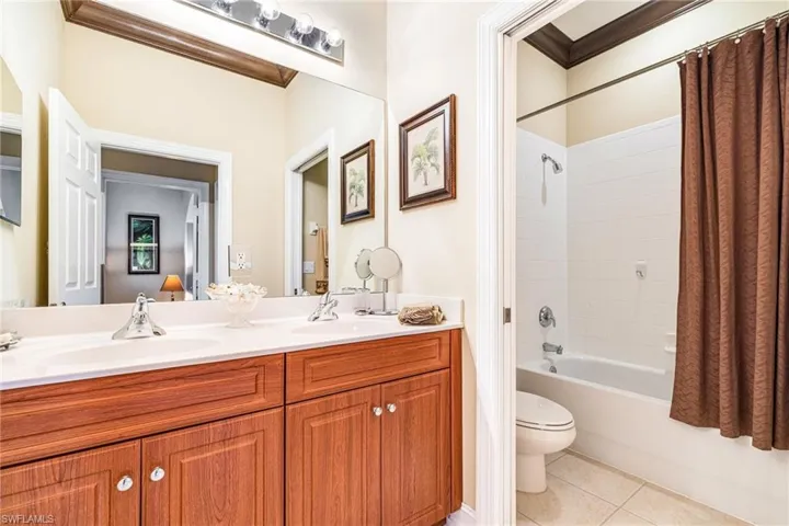 Guest Bathroom featuring shower / bathtub combination & double vanity