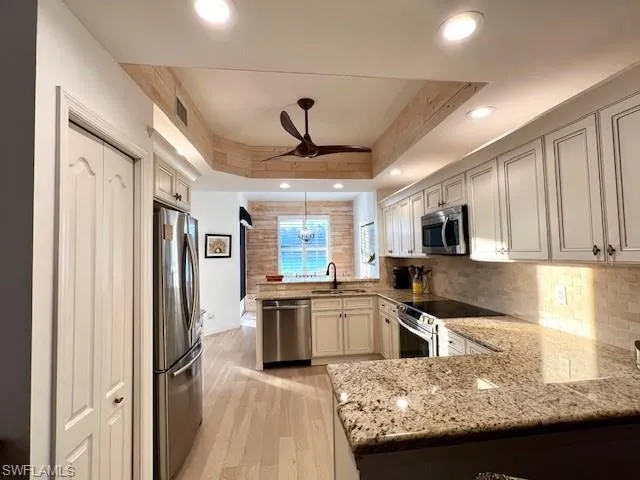 Cabinets w/crown molding, Granite counters,Travertine Backsplash, Stainless Appliances,ShipLap Accents,Minka Fan