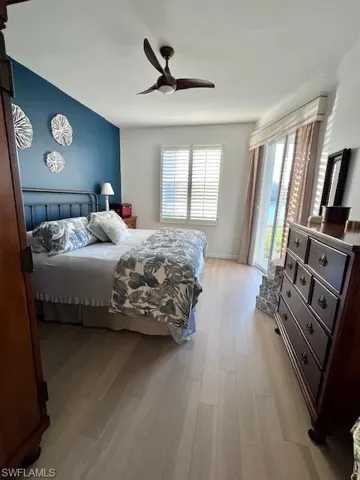 Bedroom w/Engineered Hardwood floors, Plantation Shutters, Slider to Lanai & Minka ceiling fan