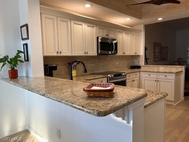 Cabinets w/crown molding, Granite counters, Travertine Backsplash, Stainless Appliances,ShipLap Accents, Minka Fan
