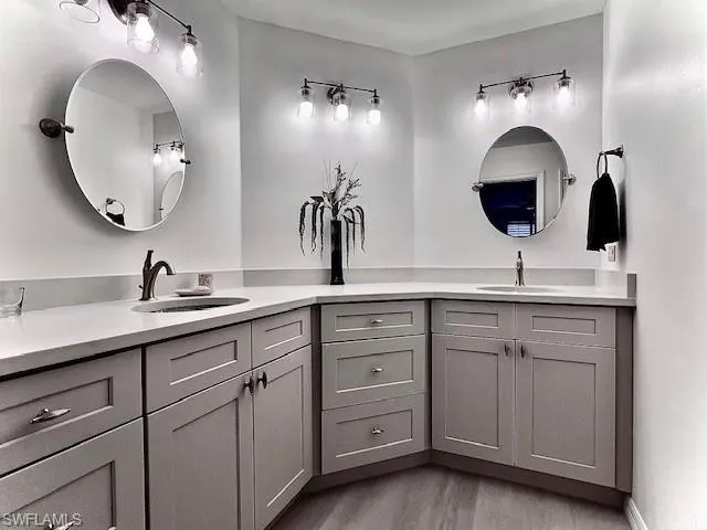 Bathroom featuring quartz counters,plank tile flooring, walk-in shower.