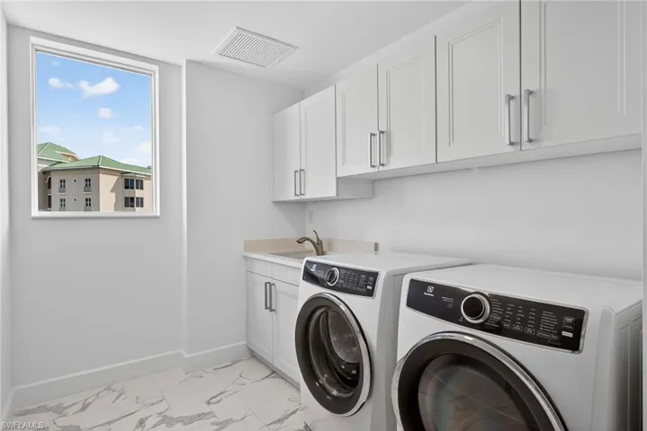 Extra cabinets in this laundry room for all your storage needs